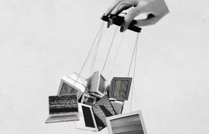black and white colored image with hand puppeteering computers