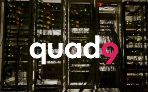 dark room with light coming through the other side of a row of tangled computer servers q9 logo up front
