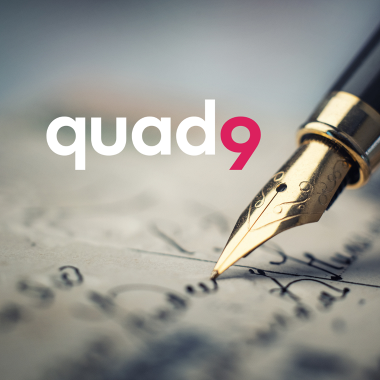 background of paper being written on with old antique pen and quad9 logo