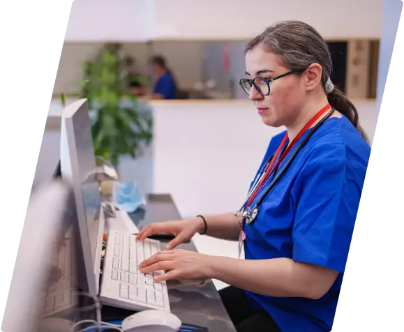 Hospital female Worker typing on a computer.
