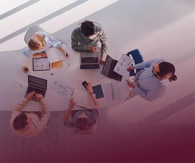 A overhead view of a group working on computers.