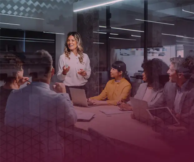 Woman in conference room presenting to a her co-workers.